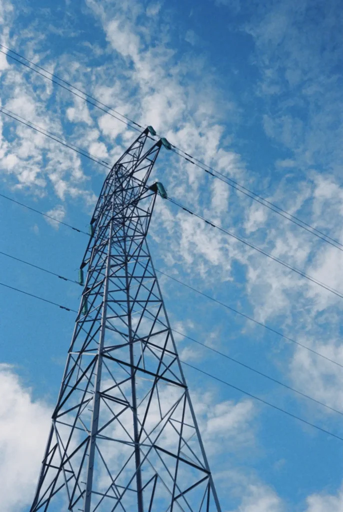 Electricity Pylon against cloudy sky