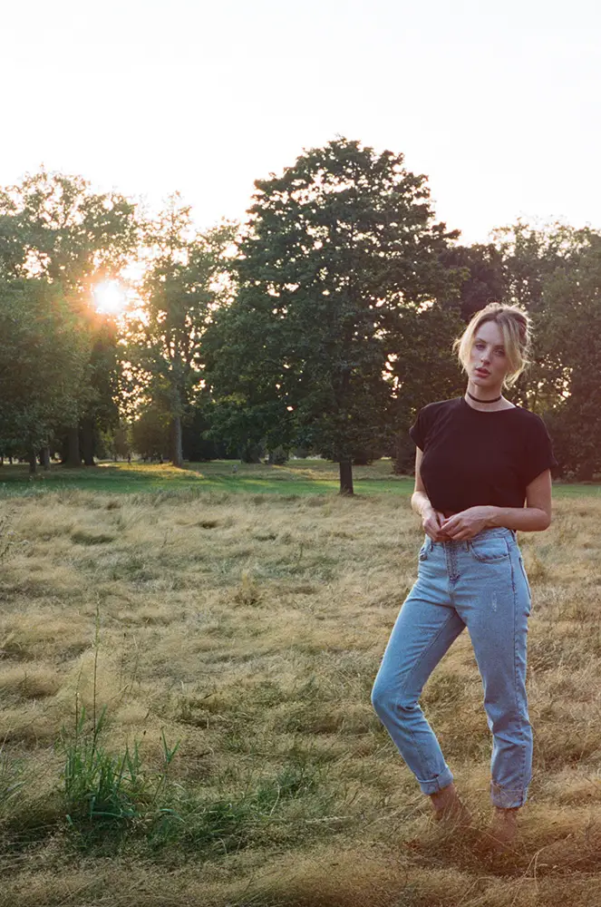 Portrait of woman standing in field photographed with Contax T2