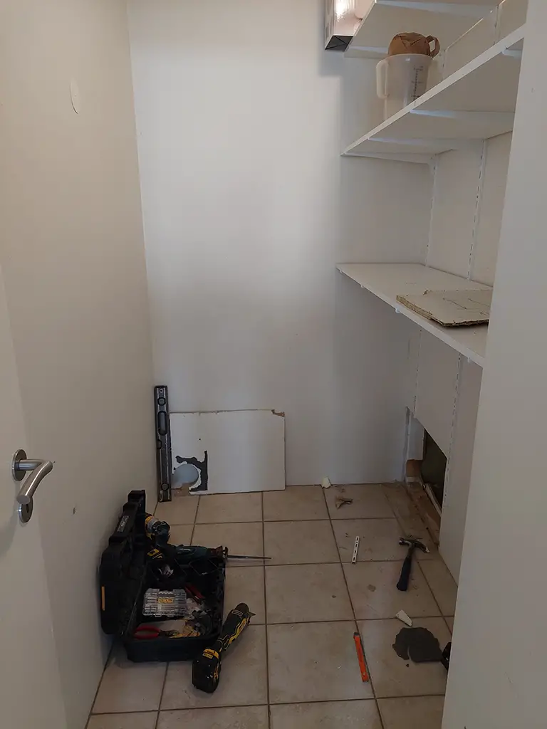 building works, empty room, tools, shelves, hole in wall