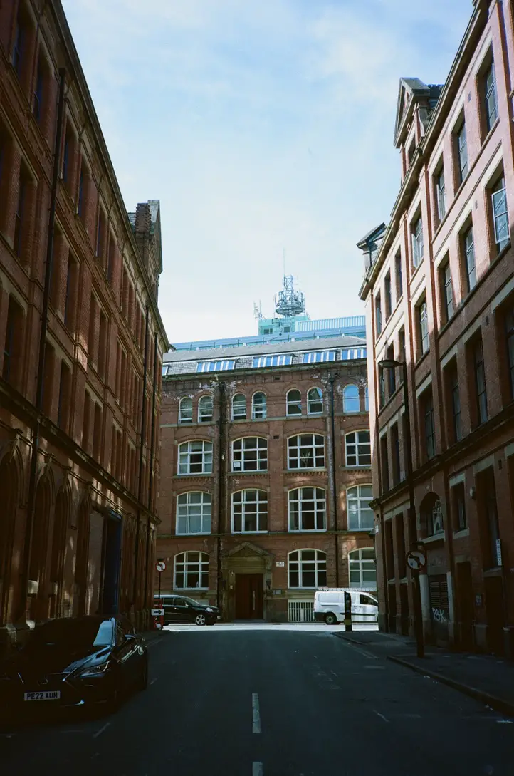Old Red Brick Building, Flanked by Two Other Old Red Brick Buildings with Deep Shadows