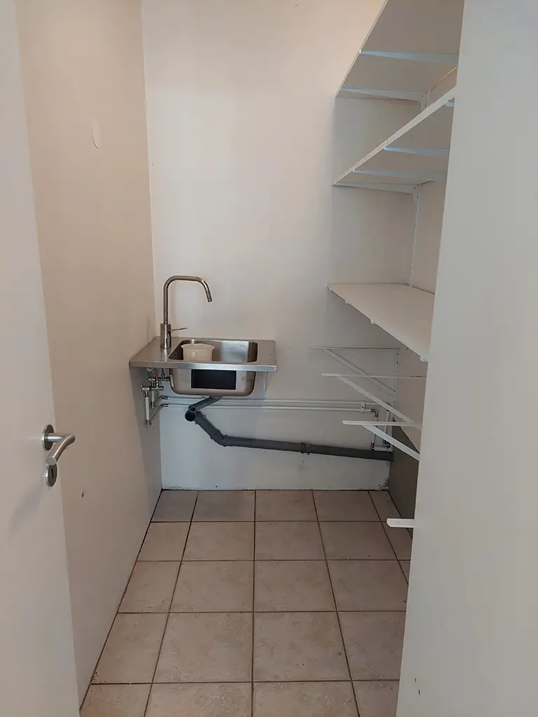 sink, pipes, shelves, empty room