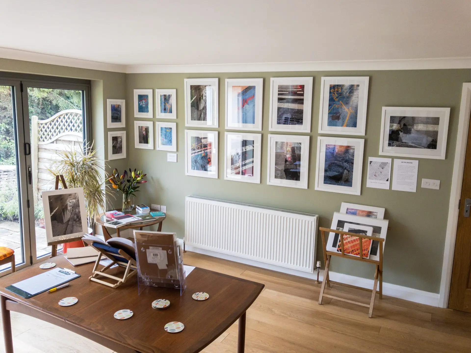 Framed photographs on the wall at home in an open-studio event