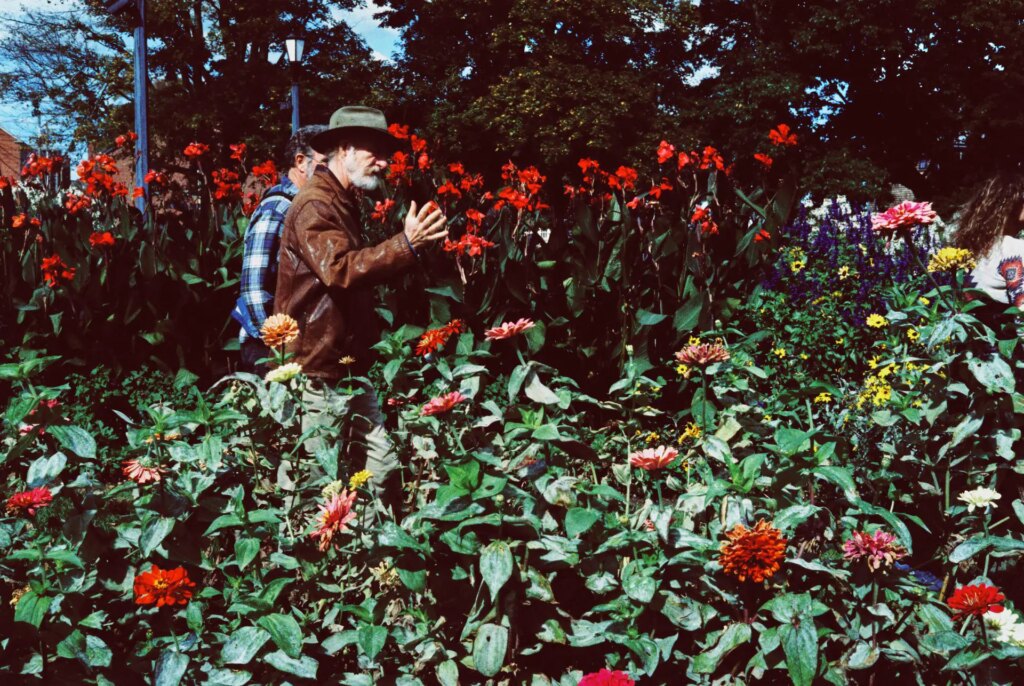 men talking in a flower garden shot on the leica cl and euphoric 100