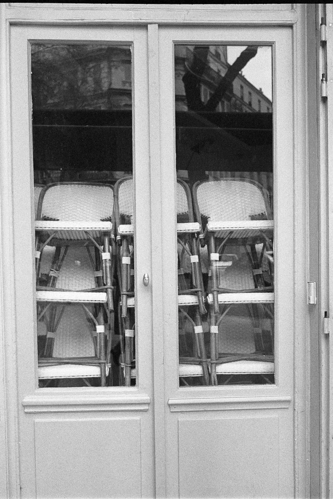 A closed café with chairs behind window