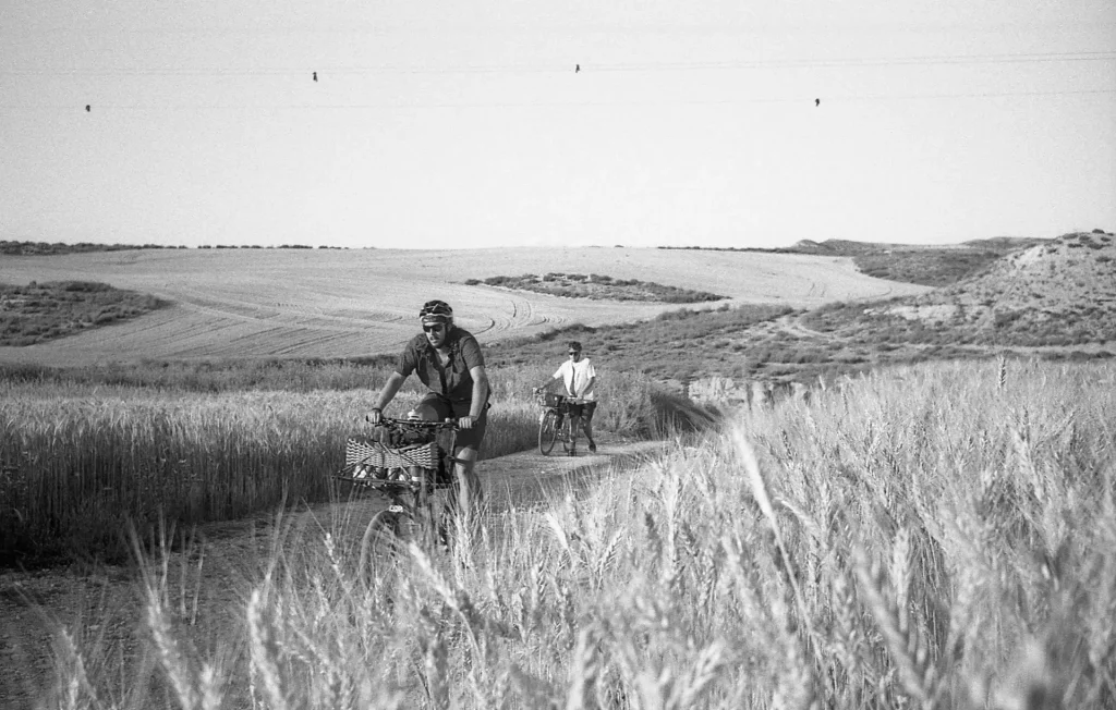  Jorge climbing a short hill in his cargobike, while Suly walks his singlespeed Cinelli