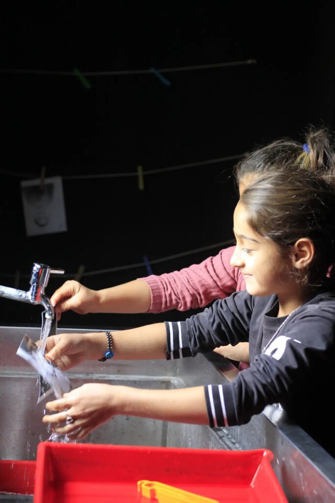 Two girls practising at the darkroom workshop