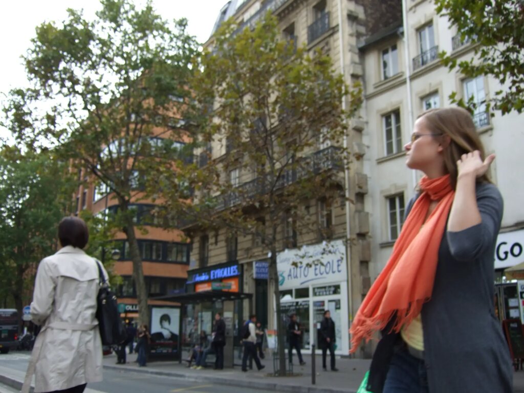 Woman seemingly lost in thought, running her hand through her hair.