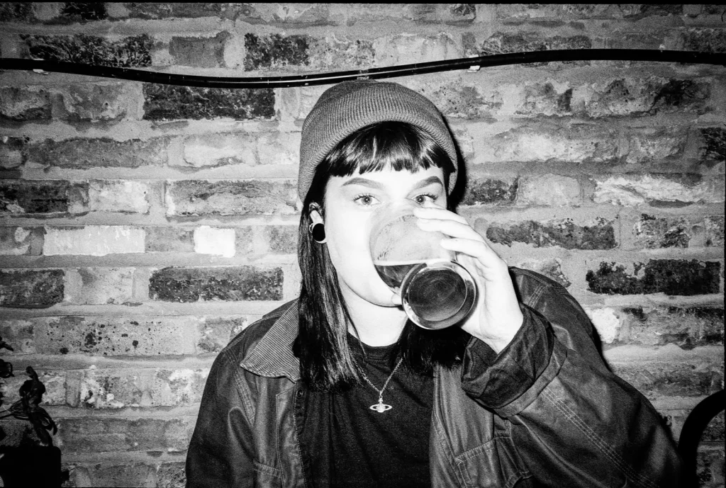 Canon SureShot Autoboy AF35MII photo of woman drinking pint 
