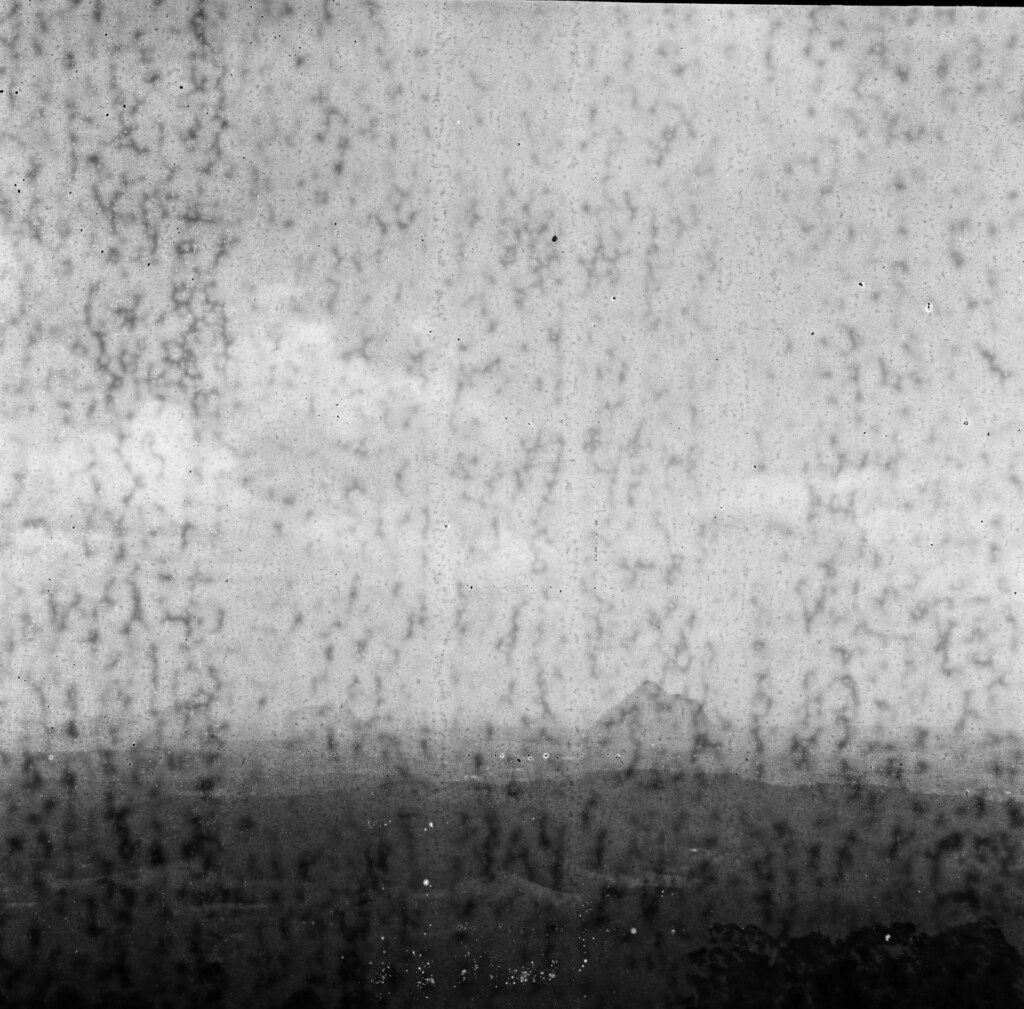 Black and white square image of a landscape of mountains