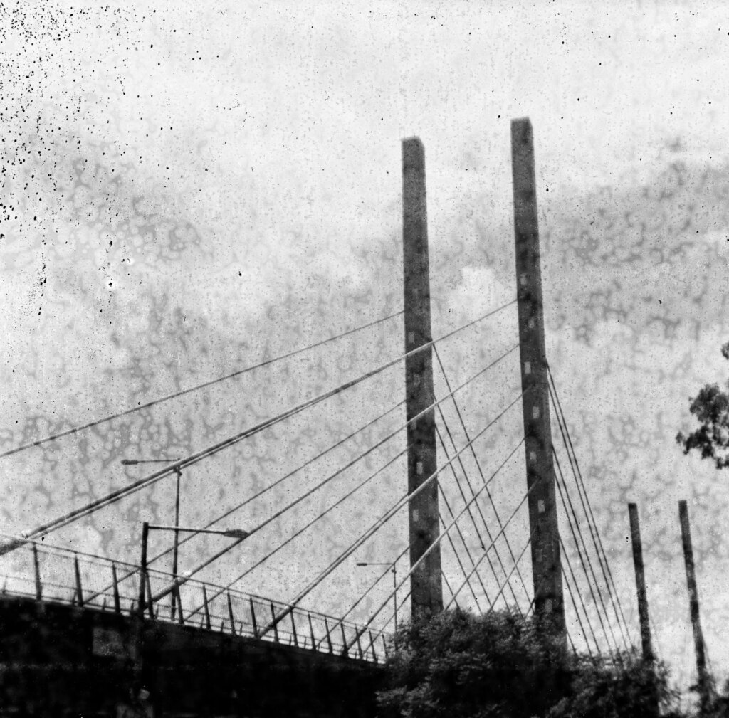 Black and white square image of a bridge