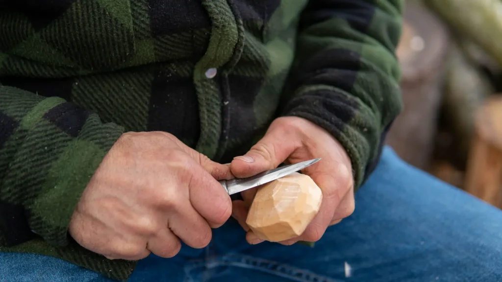 Carving a greenwood spoon with knife