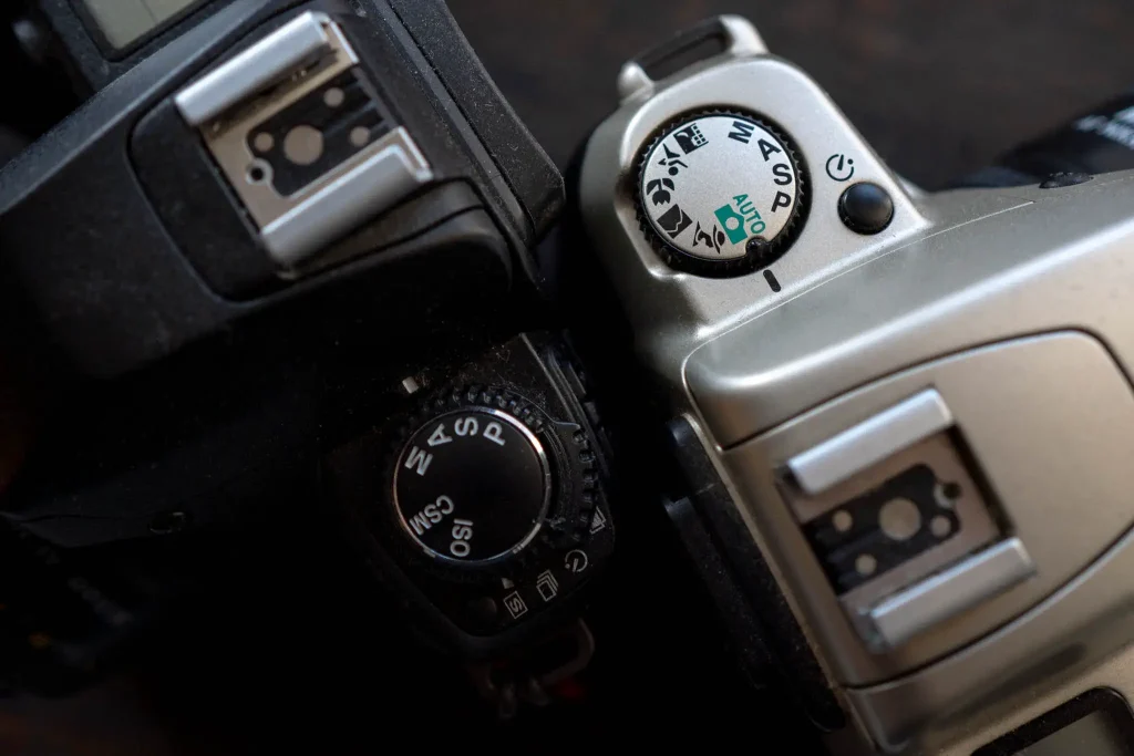 Left, the top dial has automatic modes designed for the "Enthusiast" market. Right, the green "auto" mode and scene modes; designed for the amateur