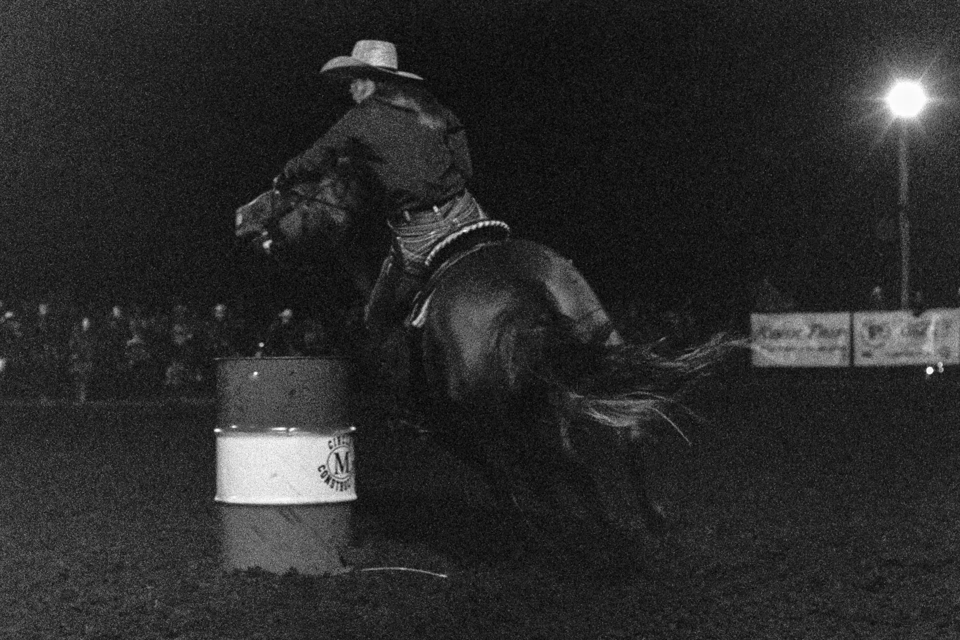 Female rider goign around barrel
