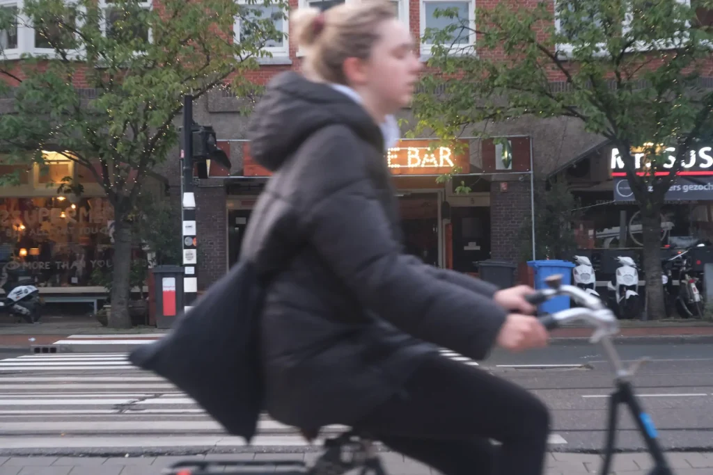 A bicyclist passing close to the camera. 