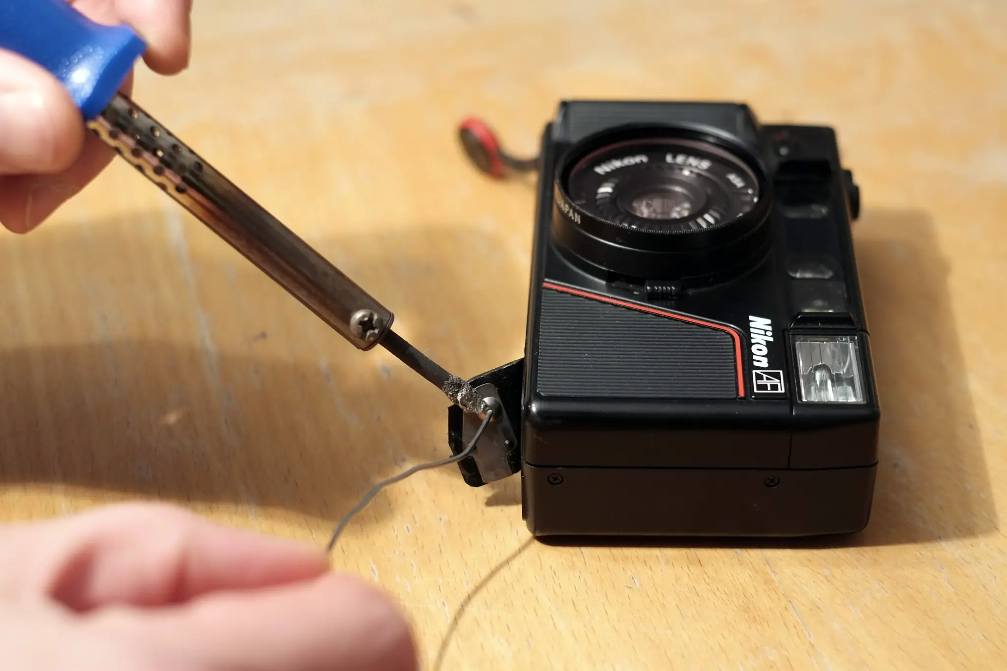 Adding a dot of solder to the battery contact