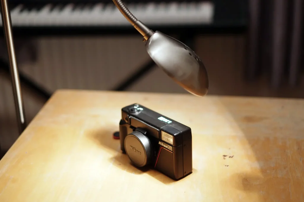 A Nikon L35AF warming up under a halogen light