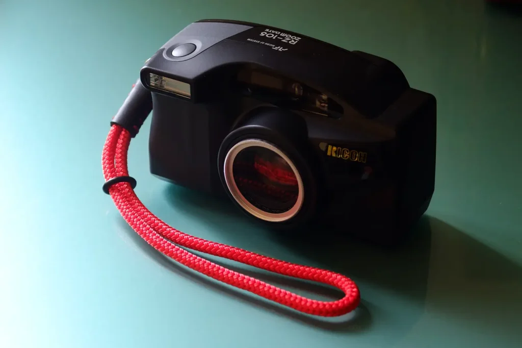 Ricoh RZ-105 Zoom Date with red wrist strap