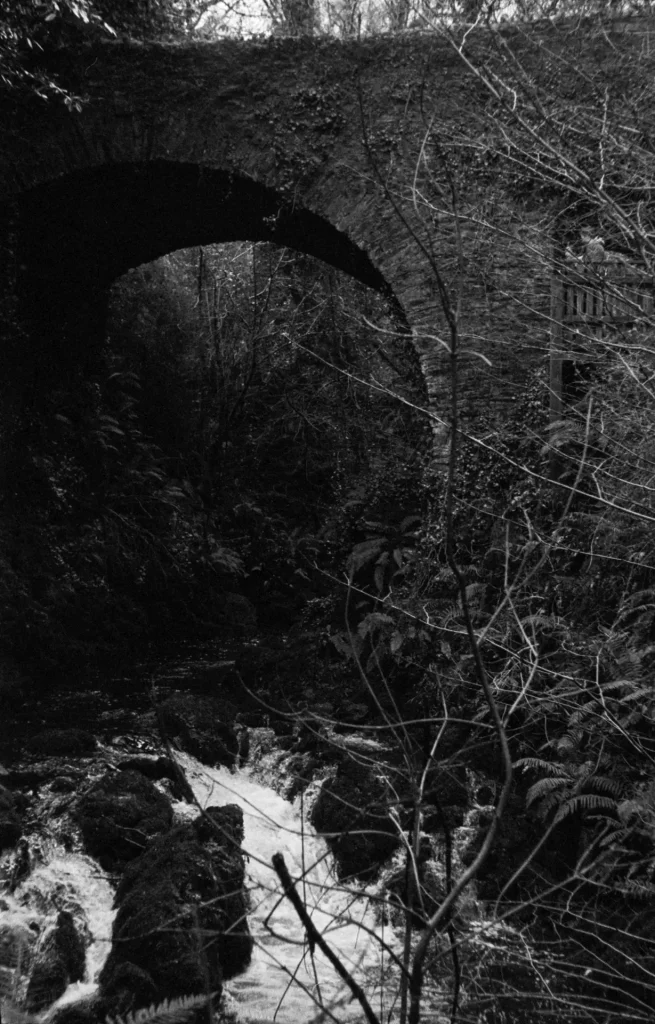 A large stone bridge over a small river