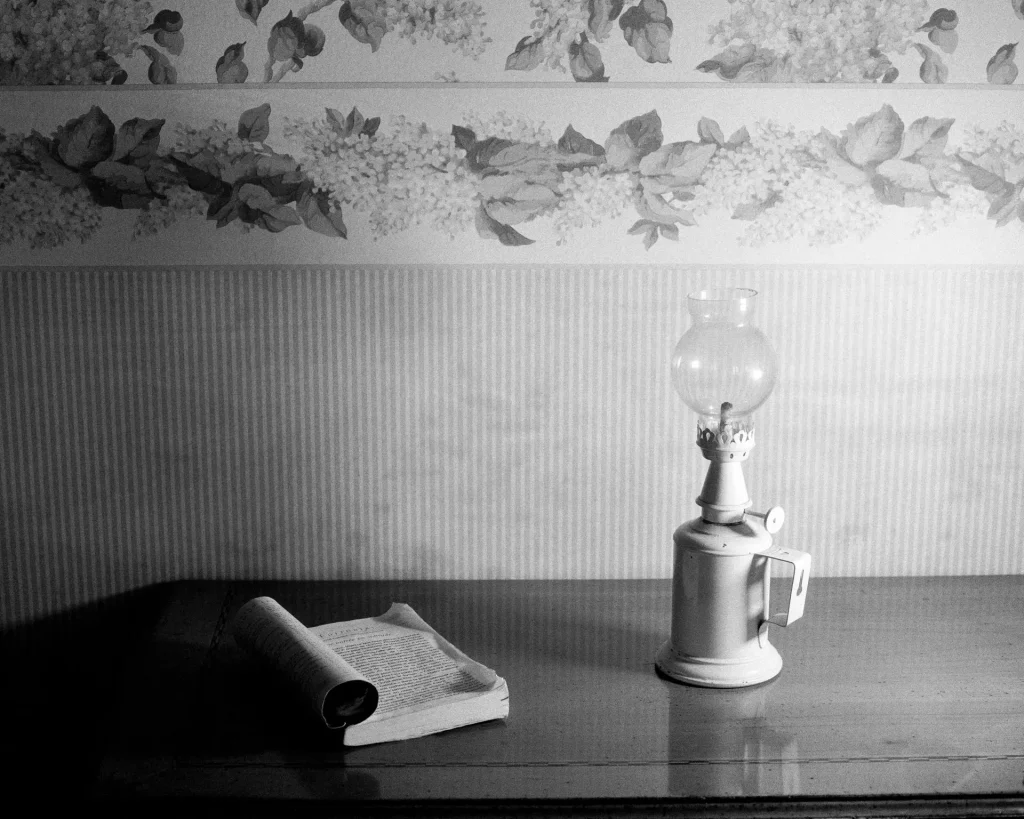 book and lamp on table