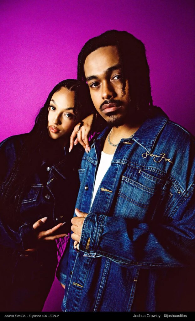 portrait of two people in studio with purple background