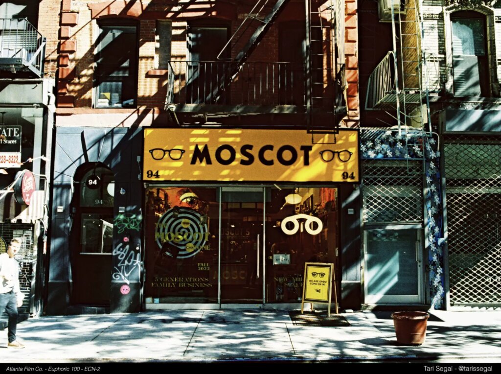 photograph of a street with moscot store sign