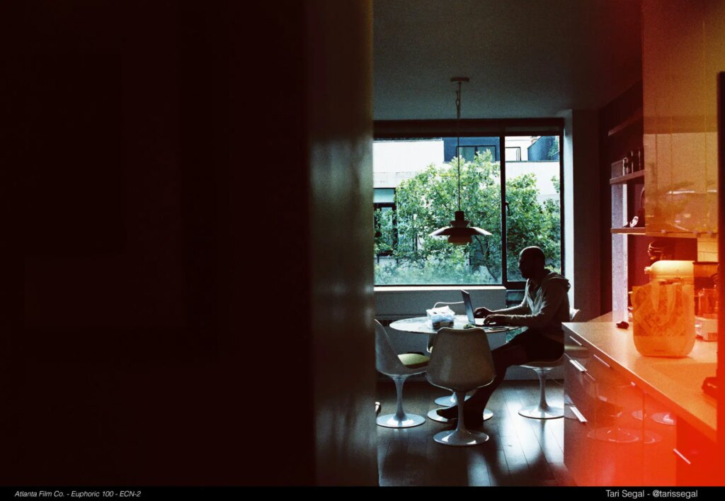 person sitting at a table next to window