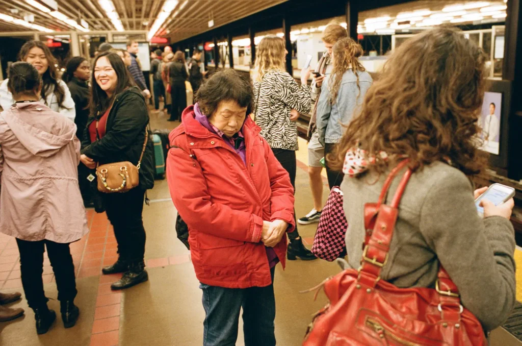 Elderly lady resting her eyes while waiting for the train