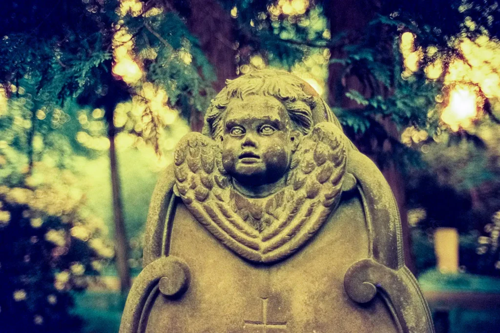 tombstone at the Engesohde cemetery in Hannover, shot on CineStill 800t film with an orange filter