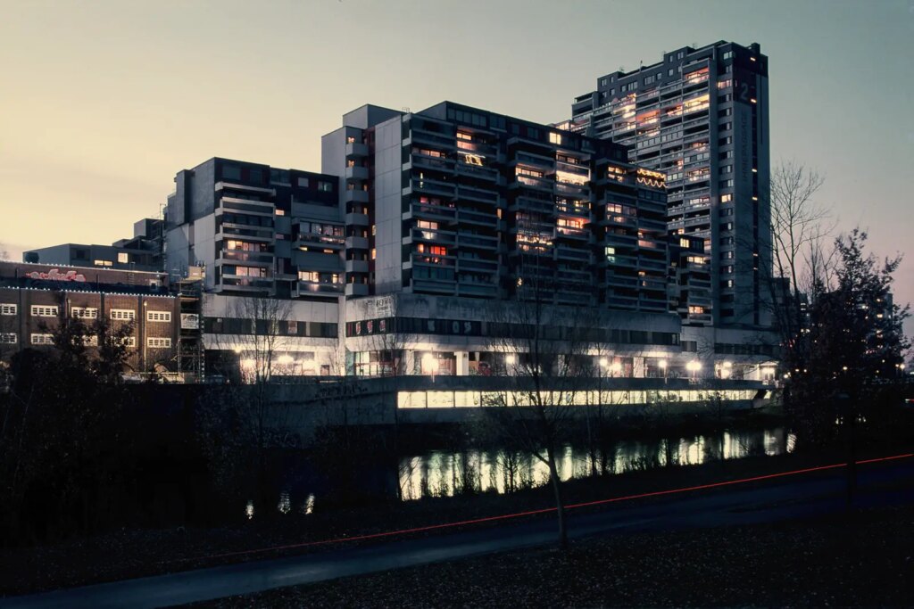 Photograph of a large apartment complex at dusk, shot on Fujichrome 64T II slide film.
