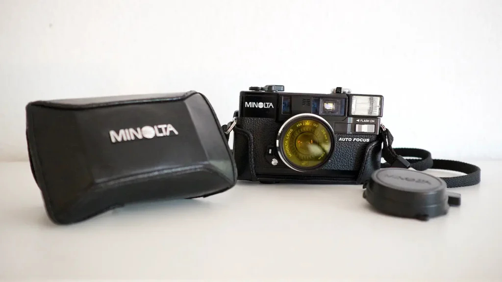 With bag and lens cap which doubles as a shutter button lock.