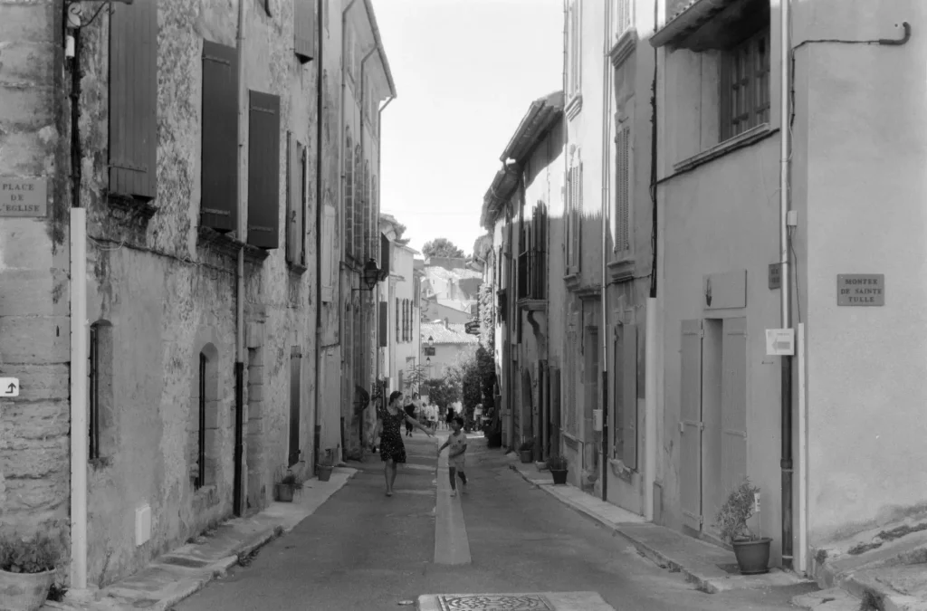 Narrow village street with people