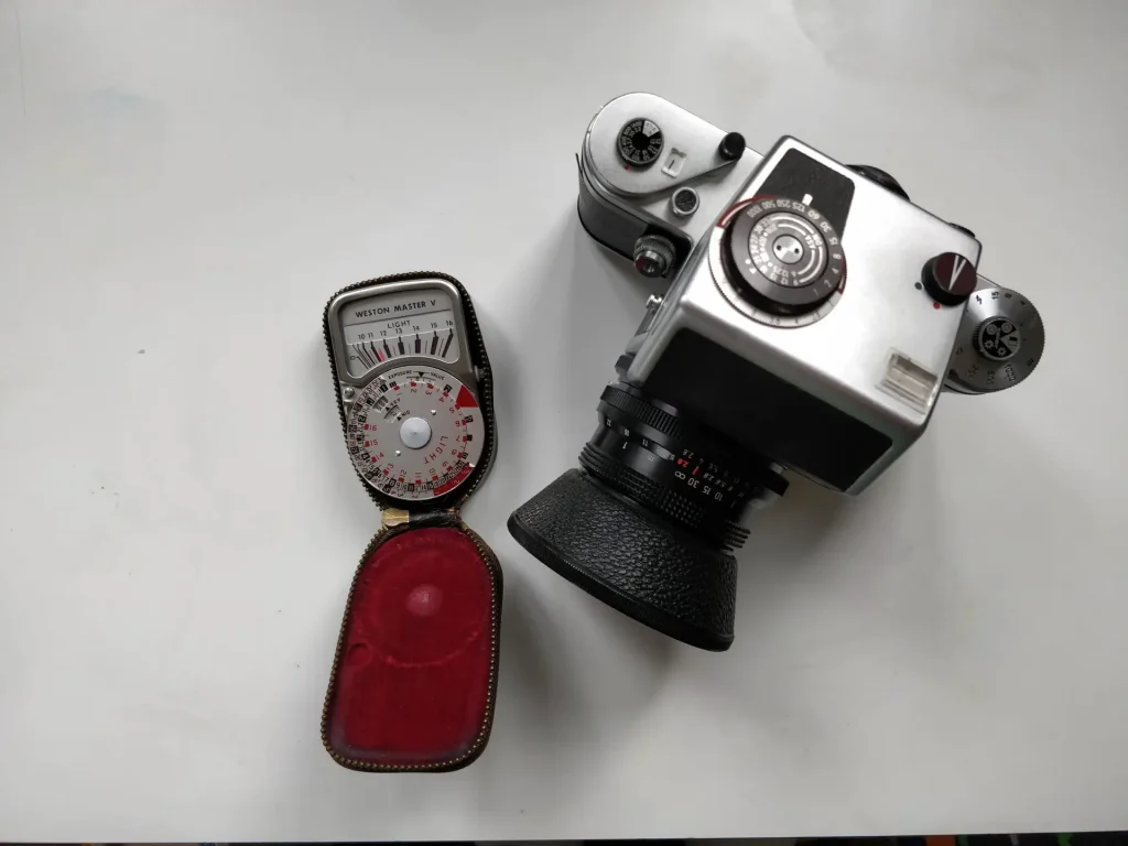 Pentacon with metering prism next to handheld meter