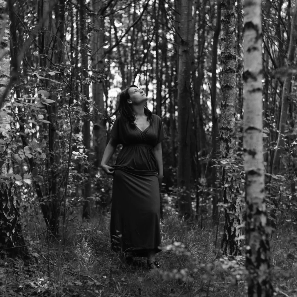 Woman Looking up through the trees