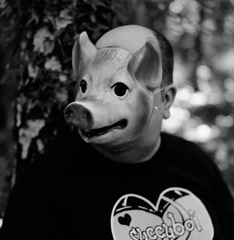 A close up of the pig masked man
