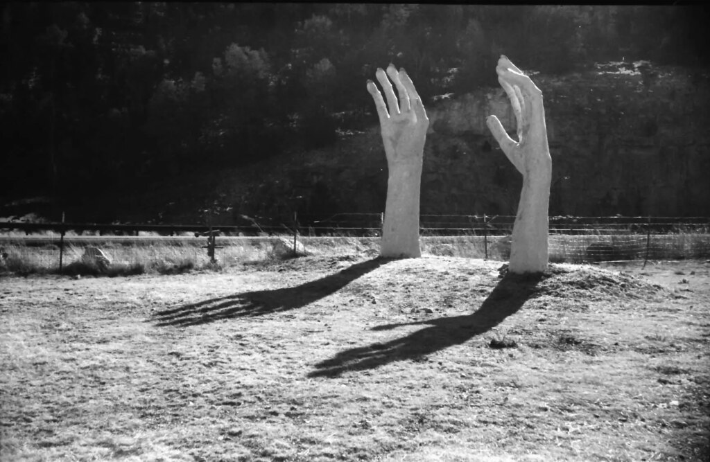 Sculpture of hands reaching out of the ground - Burmberger test 
