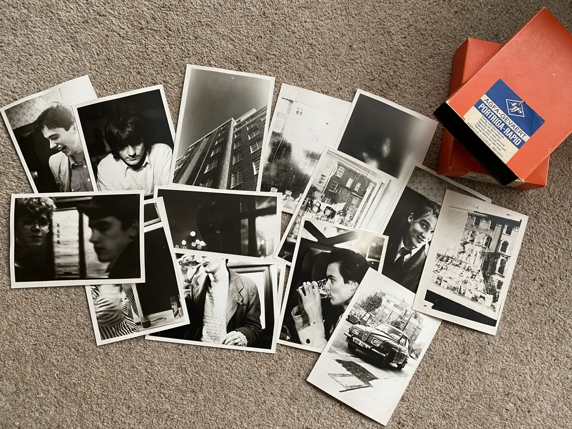 Vintage darkroom prints scattered on the floor