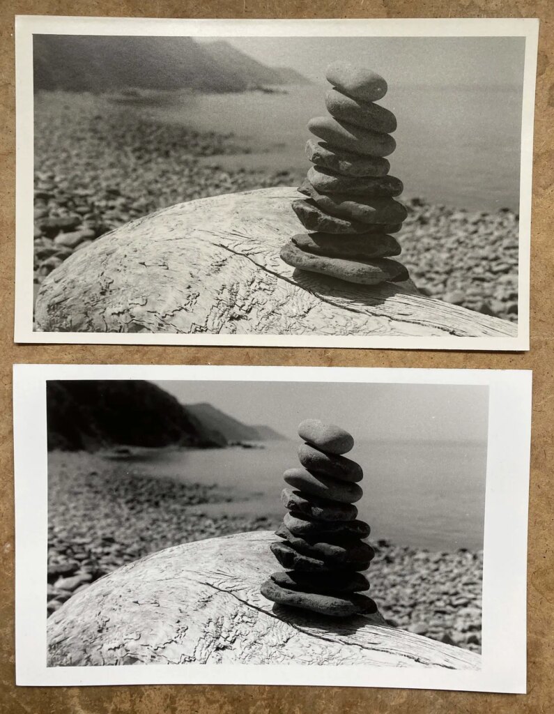 two prints of stacked stones side by side on table