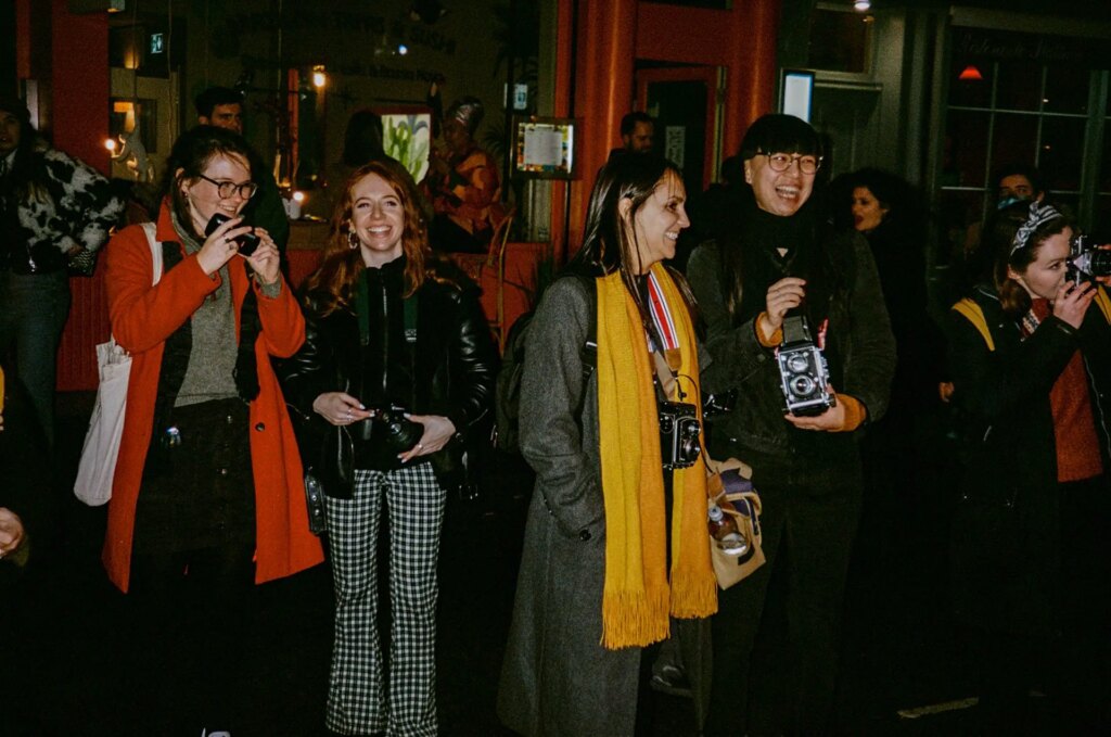 Photographers on a photowalk at night, taken with flash