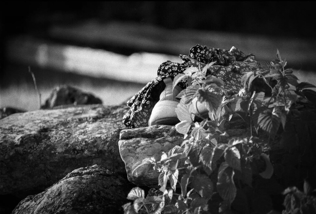 Shoes and a dress on a pile of stones