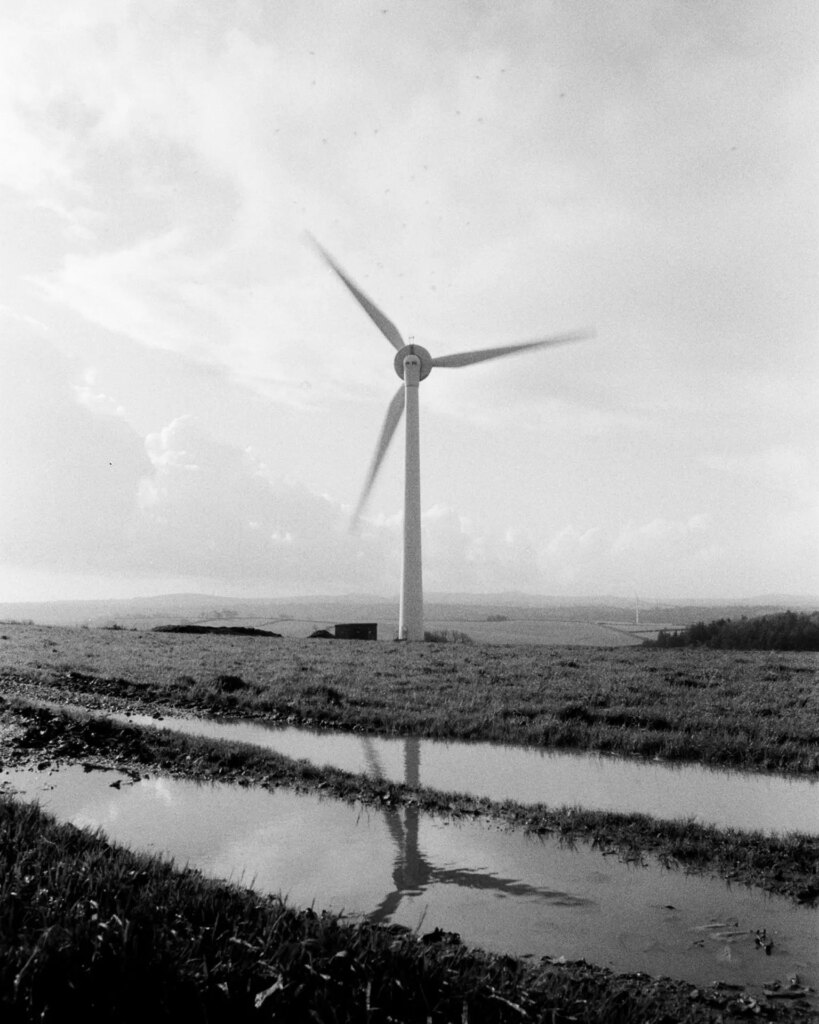 Wind Turbine, blades rotating, in a field