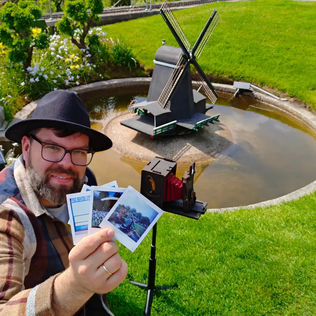 Jollylook team member showing instant film photos taken with the SQUARE pinhole camera
