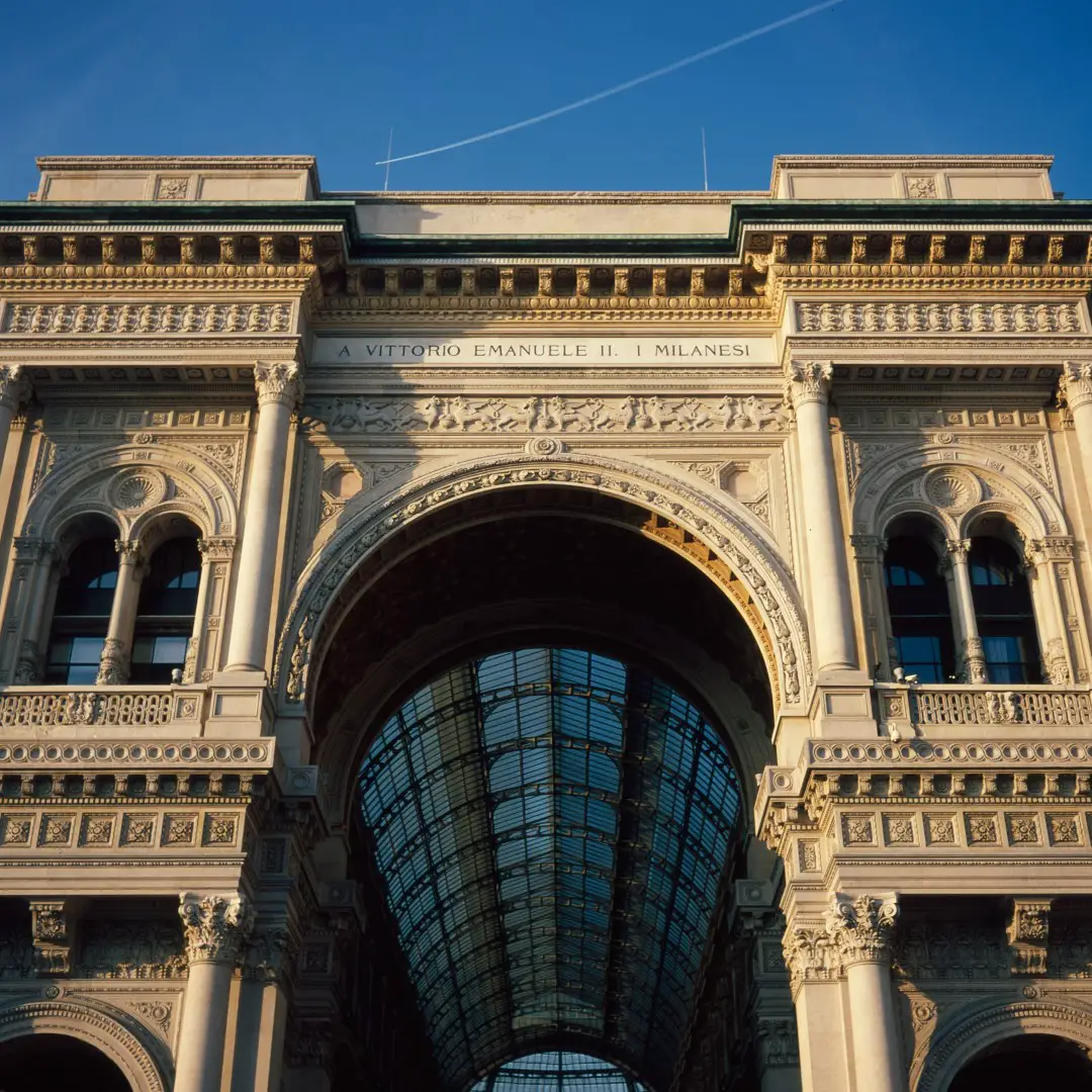 The entrance of the Galeria Vittorio Emanuele II during golden hour.