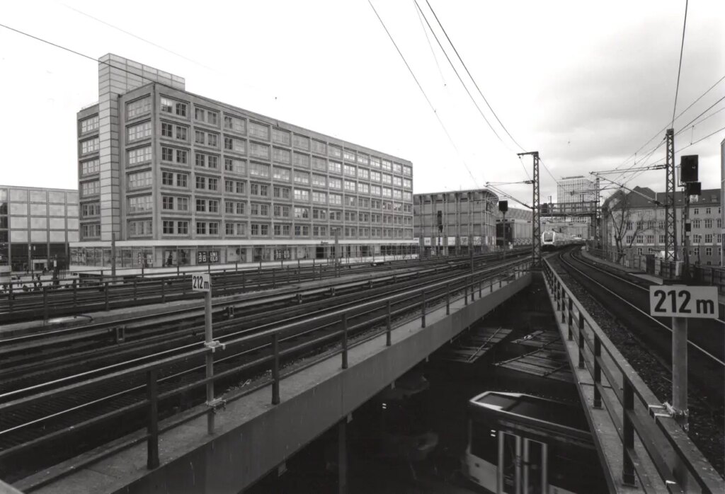 Converging lines in several planes is perfect wide angle terratory for me. The lower layer of trams running under the rail way bridge gives the image more depth and interest. A train is at the apex of the converging lines.