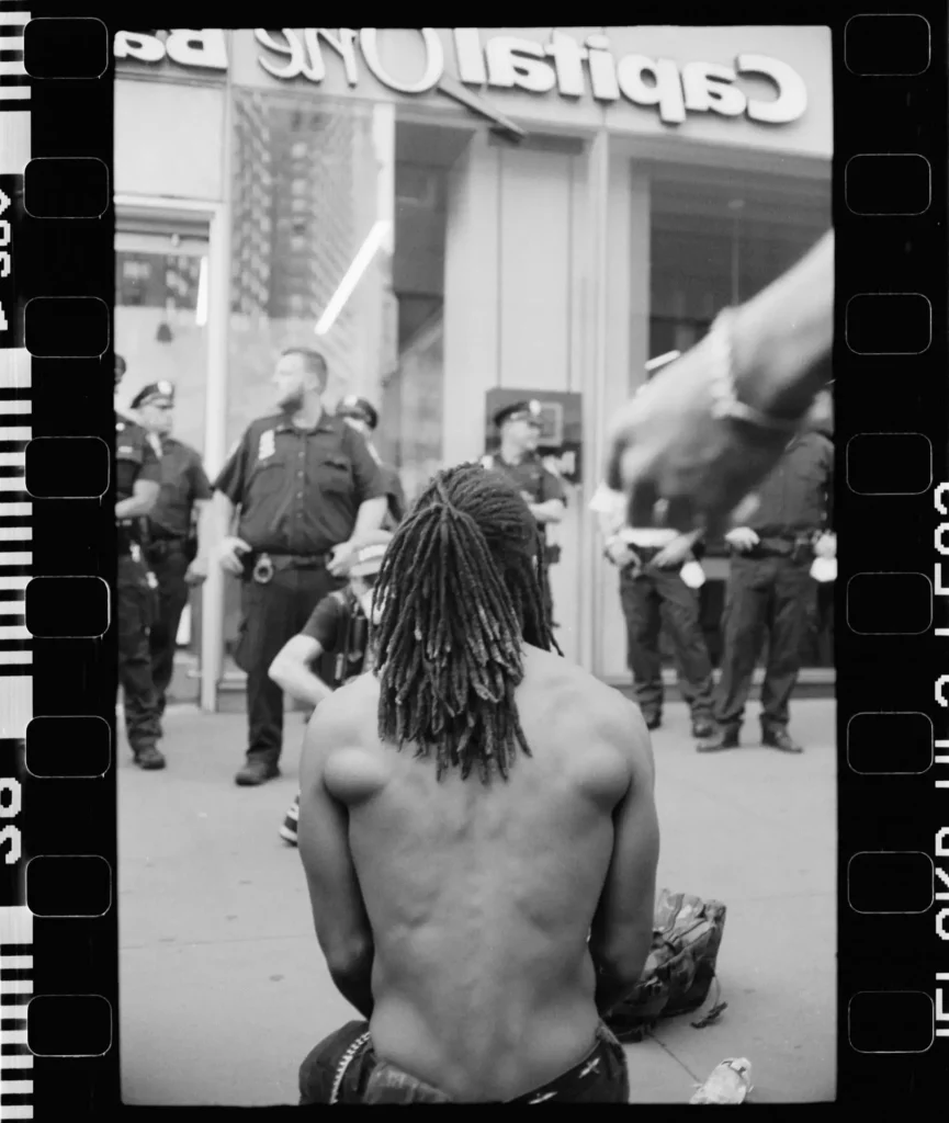 Guy kneeling before the police