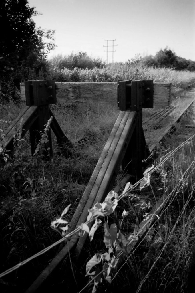 Black and white landscape with a railway line stop