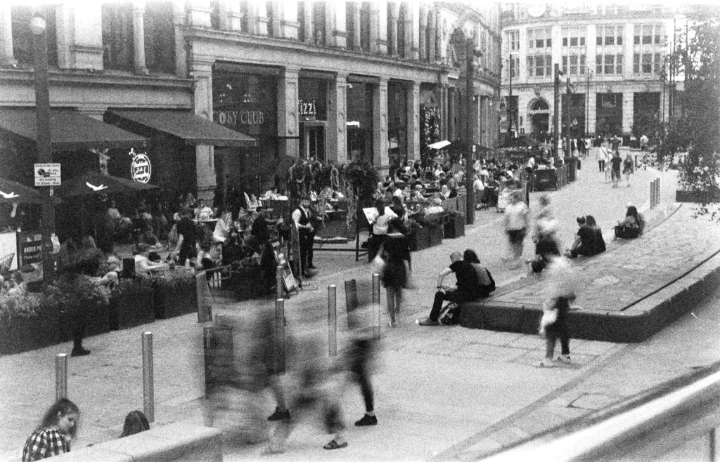 A busy street scene at Exchange Square after the first lockdown, Manchester, UK