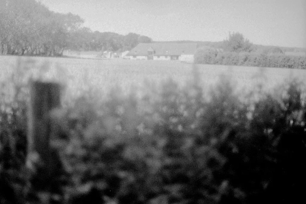 black and white photo of countryside farming