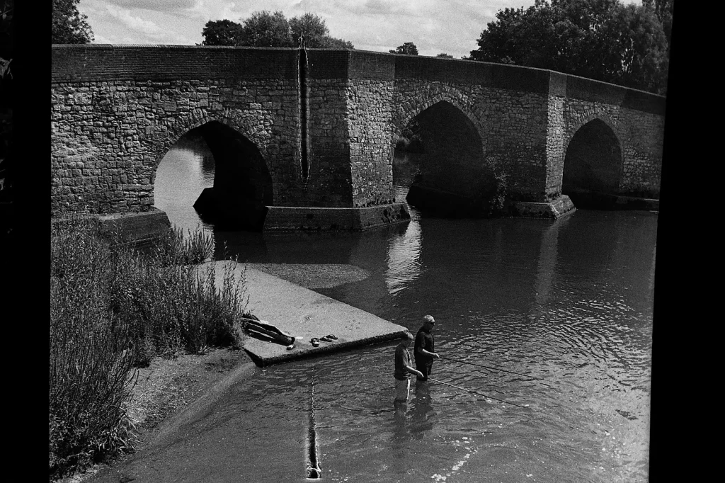 b/w photo of two men fishing