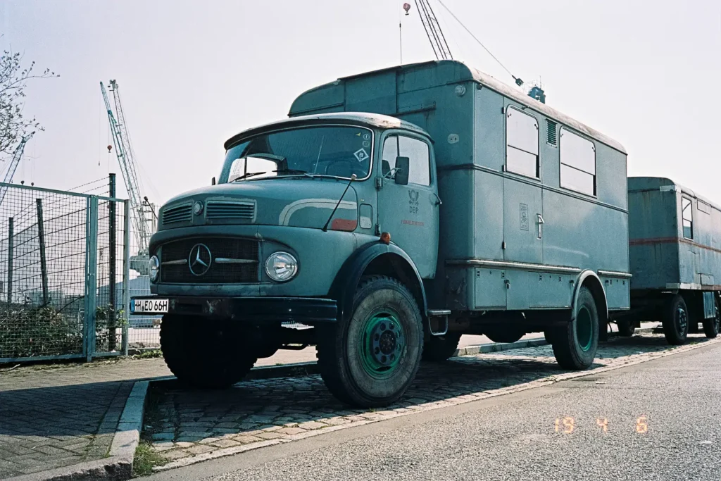 An old grey truck built by Mercedes-Benz.