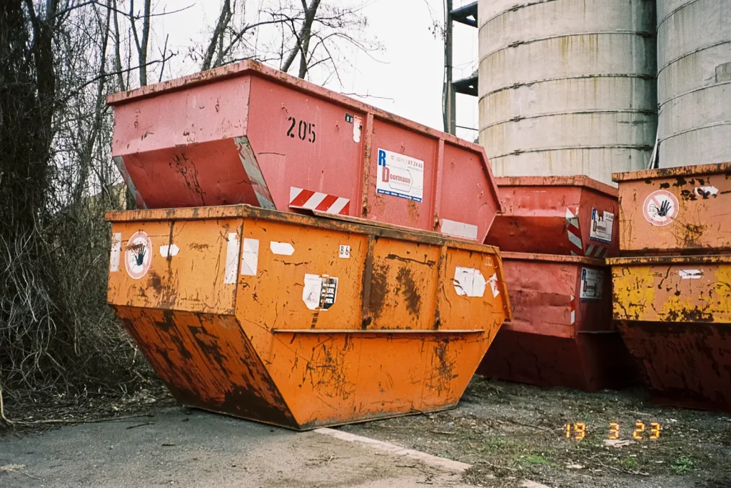 Several dumpsters stacked onto each other.